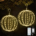 Two warm white hanging light spheres on hooks with a remote and plug adapter