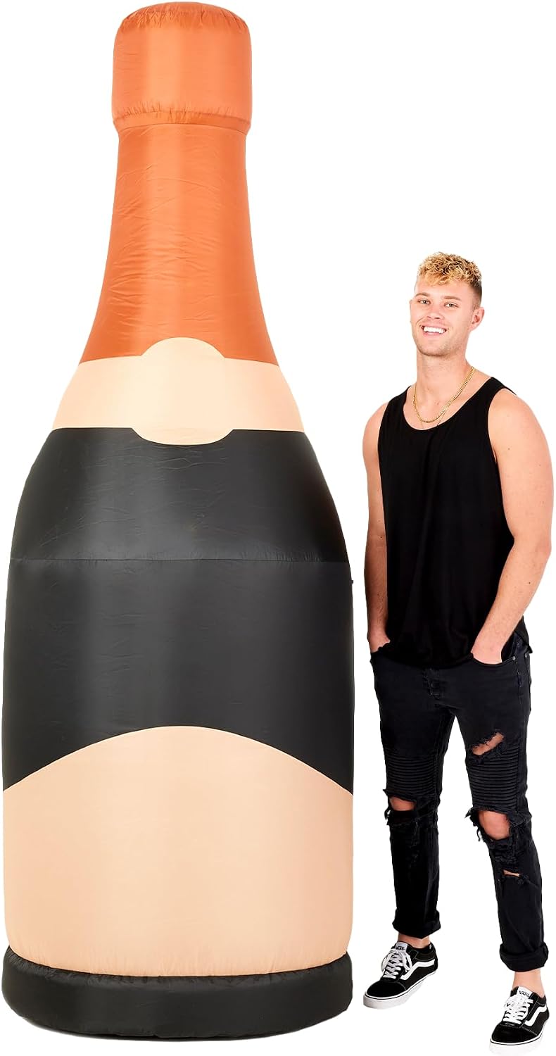 Giant black champagne bottle inflatable with a copper top next to a man for scale