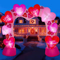 Pink archway inflatable covered in conversation hearts over a front walk at night