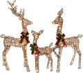 Three woven rattan-look Christmas deer with plaid bows and small lights, a buck, a doe and a fawn