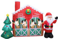 Red stable inflatable with three reindeer in the stalls, Santa at one side and a tree at the other