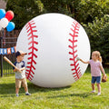 Giant white baseball inflatable with red stitching next to two children with a bat