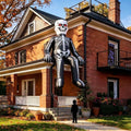Skeleton inflatable sitting on the ledge of a brick house with legs dangling
