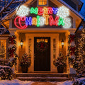 Lighted Merry Christmas LED sign in red, green and white hanging over a decorated front porch