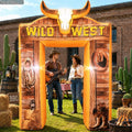 Wood-look Wild West inflatable arch with a longhorn skull at a backyard western party