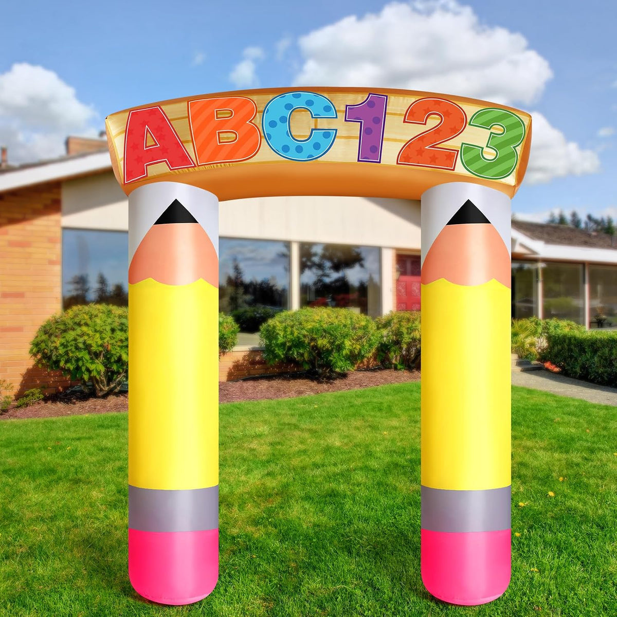 Yellow pencil arch inflatable with an ABC 123 sign on a school lawn